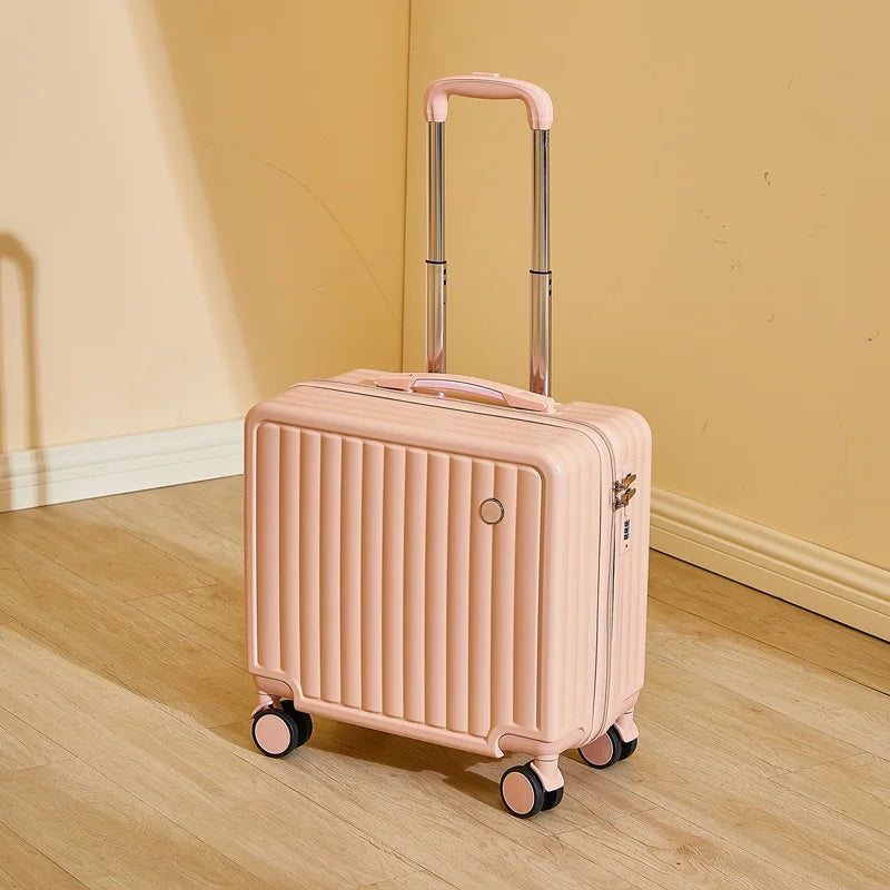 Pink suitcase with wheels on a wooden floor against a yellow wall