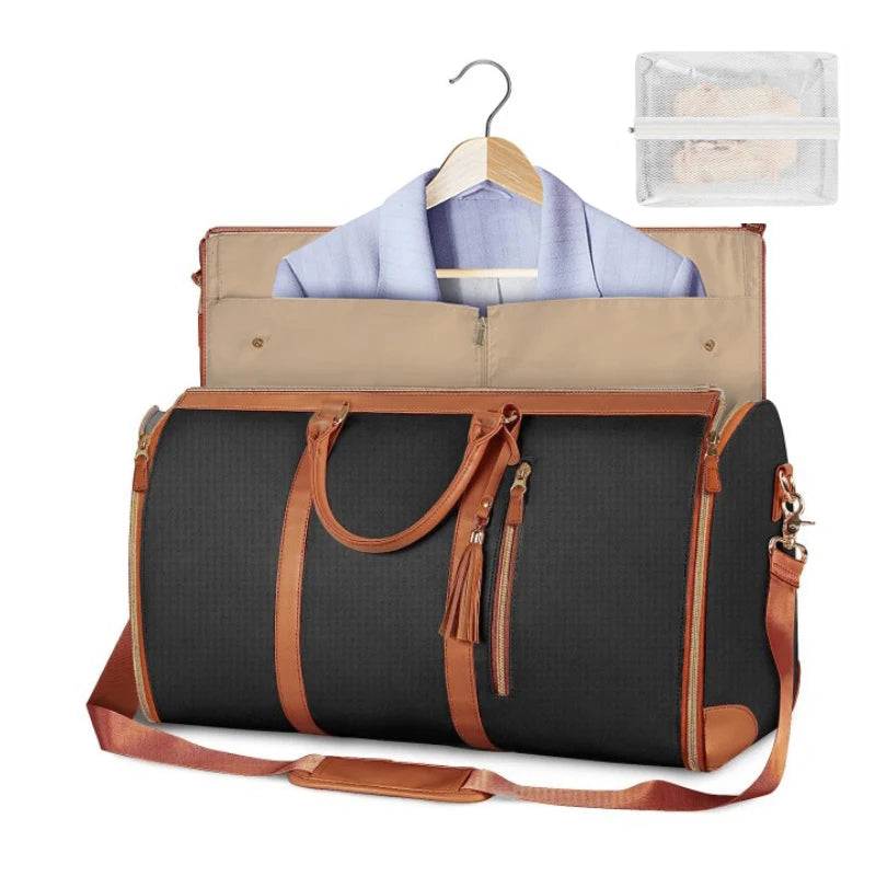 Black travel bag with brown accents, clothes on a hanger, and a clear pouch inside.