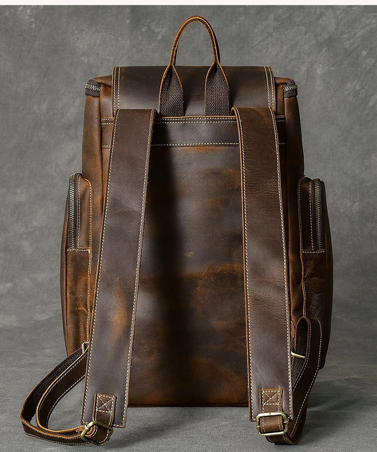 Brown leather backpack on a gray background