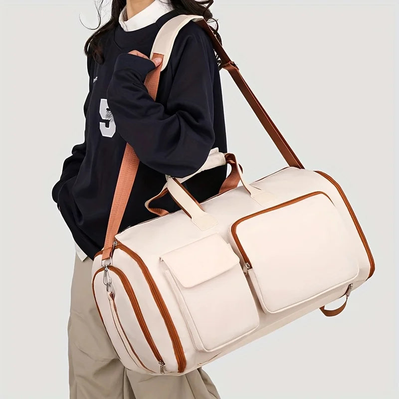 Person holding a beige duffel bag with brown accents on a light gray background
