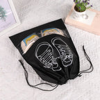Black drawstring bag with white shoe design on a textured surface
