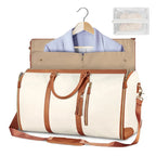 Beige and brown travel bag with clothes on a hanger, on a white background