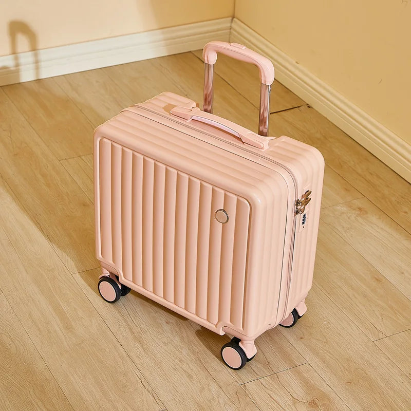 Pink suitcase with wheels on a wooden floor