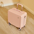 Pink suitcase with wheels on a wooden floor