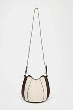 Two-tone handbag with a strap on a white background