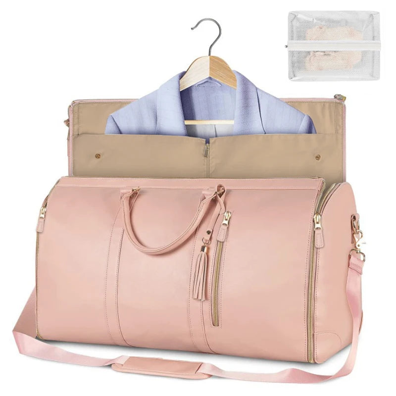 Pink duffel bag with clothes on a hanger and a clear pouch on a white background