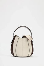 Two-tone handbag with black and beige design on a white background
