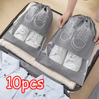 Gray shoe bags with white shoes inside, held open by a hand, with '10pcs' text on a suitcase.