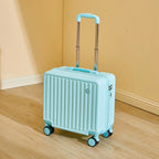Light blue suitcase with wheels on a wooden floor against a beige wall