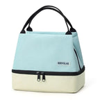 Light blue and beige tote bag with black handles and zippers on a white background